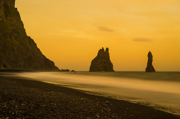 Reynisdrangar rock formations at icelandic coast. Toned long exposure shot