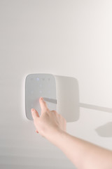 Home security concept. Woman hand entering a home security code