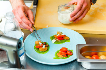 The chef in the restaurant prepares a dish