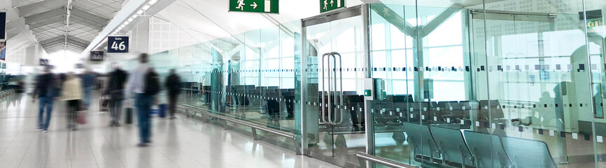 Banner of blurred people walking down airport terminal
