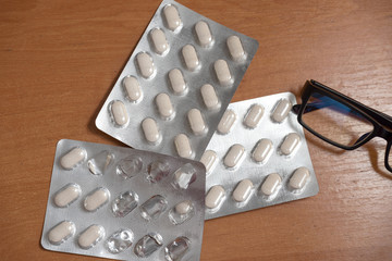 packs of pills lie on the table