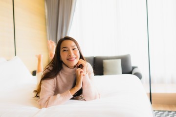Obraz na płótnie Canvas Portrait beautiful young asian woman happy smile relax on bed