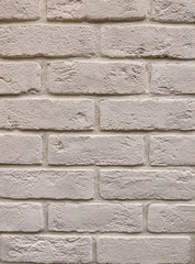 The background of the wall is a light-colored brick surface. The texture of the brick. Abstract wall background.