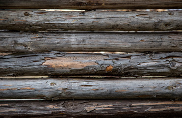 An old village fence or animal pen made of gray wooden beams. Retro