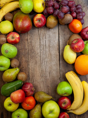 Fruit basket on a wooden kitchen table. Assorted fruits, set. Different multi-colored fruits. Vitamin nutrition.