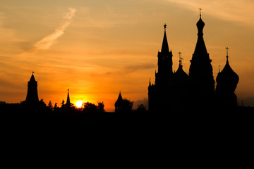 Fototapeta premium Black silhouette of Cathedral of Vasily the Blessed, Spasskaya Tower and Kremlin. Sunset sky.