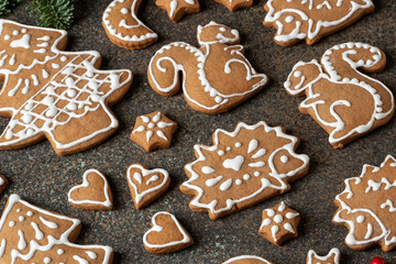 Various Christmas gingerbread cookies on a dark background