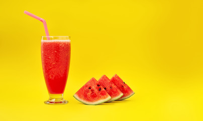 Watermelon smoothie and three slices of watermelon on a yellow background. Minimal style. Space for text