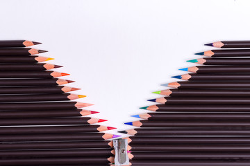 Decorative backdrop from colored pencils in the shape of opened zip on a white background.