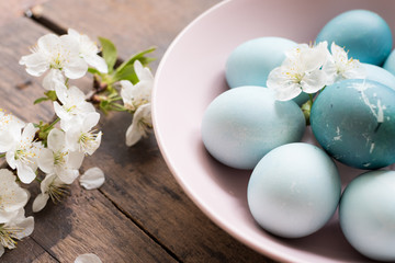 Obraz na płótnie Canvas Blue Easter eggs with spring cherry blossom