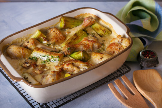 Chicken thighs and legs in sour cream sauce with leek and thyme. Horizontal image