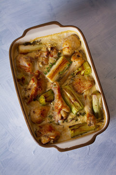 Chicken thighs and legs in sour cream sauce with leek and thyme. Overhead vertical image