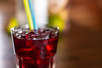 cherry red alkohol drink on wooden table closeup