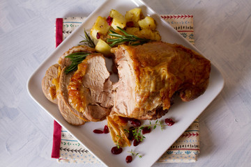 Roast turkey leg. Boned and rolled turkey leg with potatoes and cranberries. View from above, top view