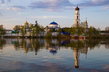 Obraz premium Panoramic view of the Raifa monastery from the lake. Sunset sky. Mirror reflection in the water. Beautiful russian nature. 
