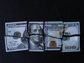 A torn hundred dollar bill
