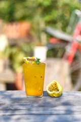 Passion fruits juice. Herbal drink Passion fruit on the old wood texture,natural patterns with knots and nail holes. lemon and syrup. The concept of herbal water to cure thirst. Vertical image