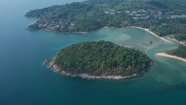 Aerial drone view of small island near tropical Layan Beach area in Phuket, Thailand