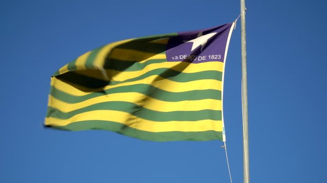 Beautiful flag of Piau&iacute; state waving in the wind on sunny summer day with blue sky. Concept of state, symbol, republic, Brazil, cultural identity, democracy, geography and politics.