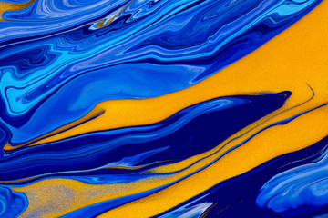 Fluid art texture. Background with abstract mixing paint effect. Liquid acrylic picture that flows and splashes. Mixed paints for posters or wallpapers. Blue, golden and cyan overflowing colors