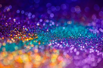 Festive twinkle glitters background, abstract sparkle backdrop with circles,modern design overlay with sparkling glimmers. Yellow, blue, purple and green backdrop glittering sparks with glow effect