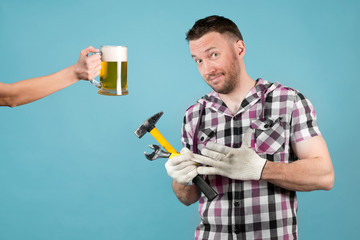 A dirty hard worker is going to have beer after hard work