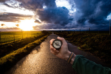landscape photo and a compass in a hand. travel concept. © PintoArt