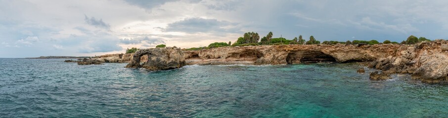 Panorama of rocky coastline landscape of Mediterranean sea at sunset in the province of Syracuse in Sicily