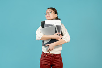 Girl hugs a large stack of documents and folders.