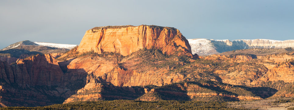 Burnt mountain and Kolob fingers glow in the evening light of a winter day with the snow covered plateau of Kolob mountain behind them. - Powered by Adobe