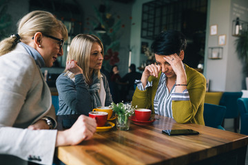 women consoling their friend