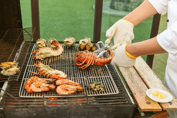 Lobster grilled barbecued seafood in BBQ Flames.