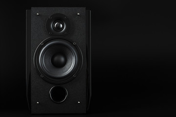 Multimedia speaker column on a black background. Free space for text.