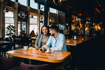 man and woman couple drinking coffee in cafe