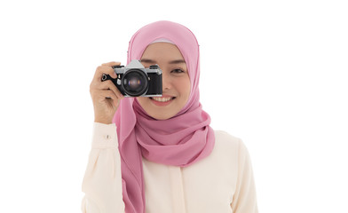 Fototapeta premium Muslim woman in hijab take photo with camera and smiling isolated on white background with clipping path. Concept of hobby, travel, memory, vacation.