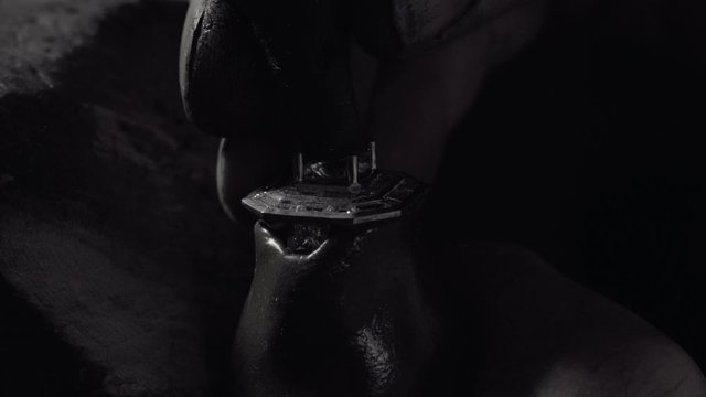 Man crafting a diamond ring jewel with his tools 