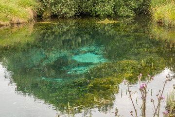 Blue water source bottom of a small lake