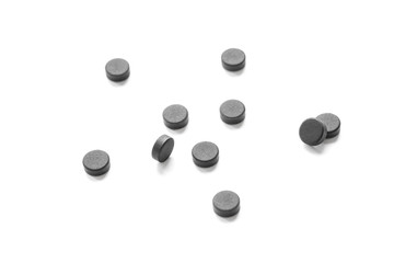 Medical tablets. The activated coal isolated over white.