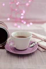 chocolate cup with lights background in pink