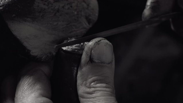 Man crafting a diamond ring jewel with his tools 