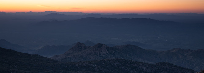 Colorful orange sunset from Kitt Peak Observatory over Arizona desert hills