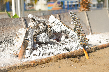 view of the coast of Malaga at a stake in a boat grilled on charcoal grilled fish smelt fish national tradition of Spain