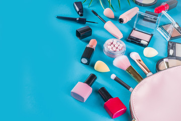 Professional makeup cosmetic set, with summer tropical leaves, woman bag. Make up items. luxury decorative cosmetics flatlay, top view, mockup. Beauty blogger concept. Trendy turquoise background