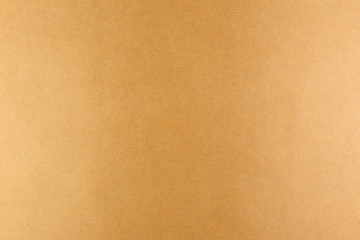 Brown background of real colored paper, illuminated by a soft light on the sides.