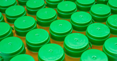 The lid of the water bottle that closes the bottle containing orange juice, which is arranged in an ice bucket to prepare for distribution to customers..