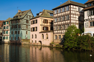 Naklejka na ściany i meble Medieval traditional half-timbered houses in the Petite France district. Pastel colors of early spring. Strasbourg, Alsace, France.