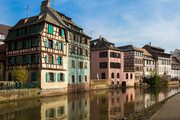 Fototapeta na wymiar Medieval traditional half-timbered houses in the Petite France district. Pastel colors of early spring. Strasbourg, Alsace, France.