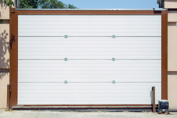 Shutter door or roller door and concrete floor outside .White Automatic shutters in a house . gates...