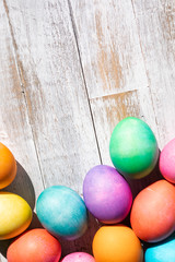 Bright And Colorful Easter Eggs On Weathered Wood