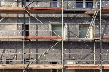 Scaffold and polystyrene panels for thermal insulation on a house facade of an old building